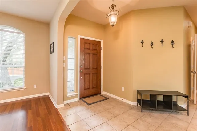 a view of a hallway with wooden floor and dining room