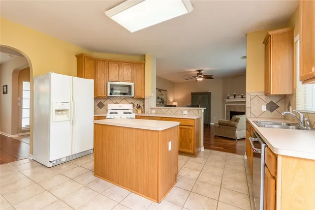 a kitchen with a sink stove and cabinets