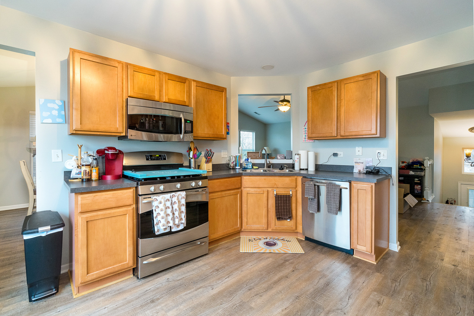 15311 Pinewood Road, Unit 15311 Lockport, IL 60441 - Photo 2 of 17 a kitchen with stainless steel appliances granite countertop a stove a sink and a microwave