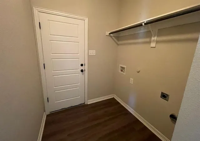 a view of walk in closet with wooden floor