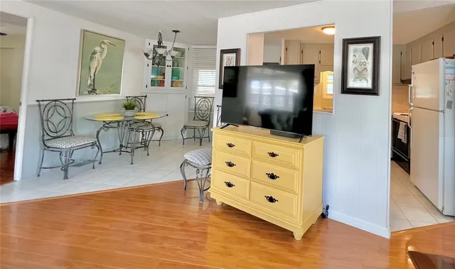 a kitchen with stainless steel appliances a stove a sink and white cabinets