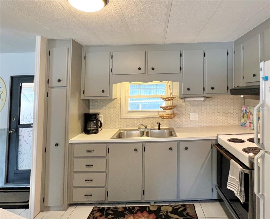 1100 South Belcher Road, Unit 245 Largo, FL 33771 - Photo 24 of 69 a kitchen with a sink and cabinets