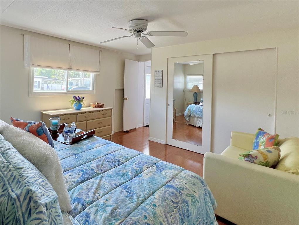 1100 South Belcher Road, Unit 245 Largo, FL 33771 - Photo 28 of 69 a bedroom with a bed and a chandelier