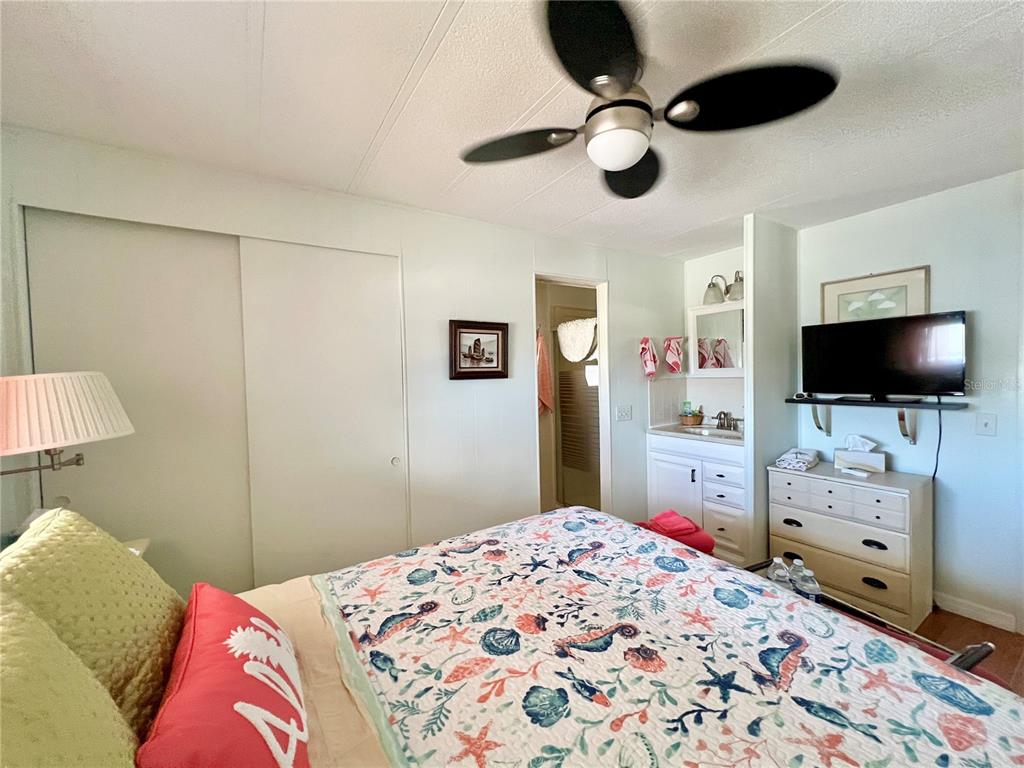 1100 South Belcher Road, Unit 245 Largo, FL 33771 - Photo 33 of 69 a bedroom with a bed and a flat tv screen on dresser