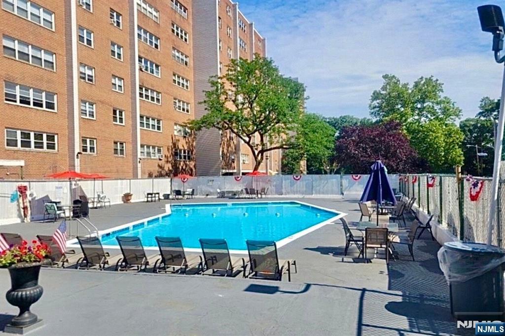 39 East 39th Street, Unit 1E Paterson, NJ 07514 - Photo 16 of 18 a view of a swimming pool with outdoor seating and plants