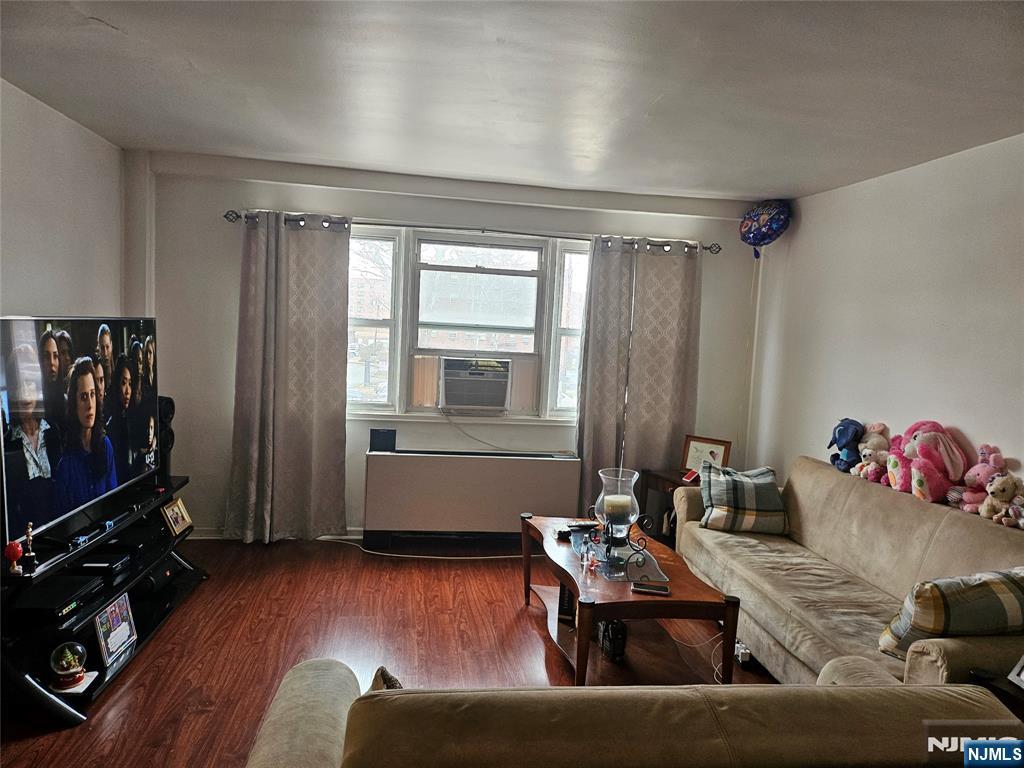 39 East 39th Street, Unit 1E Paterson, NJ 07514 - Photo 3 of 18 a living room with furniture and a flat screen tv