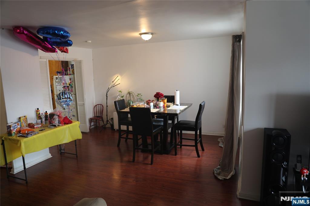 39 East 39th Street, Unit 1E Paterson, NJ 07514 - Photo 5 of 18 a view of a dining room with furniture and wooden floor