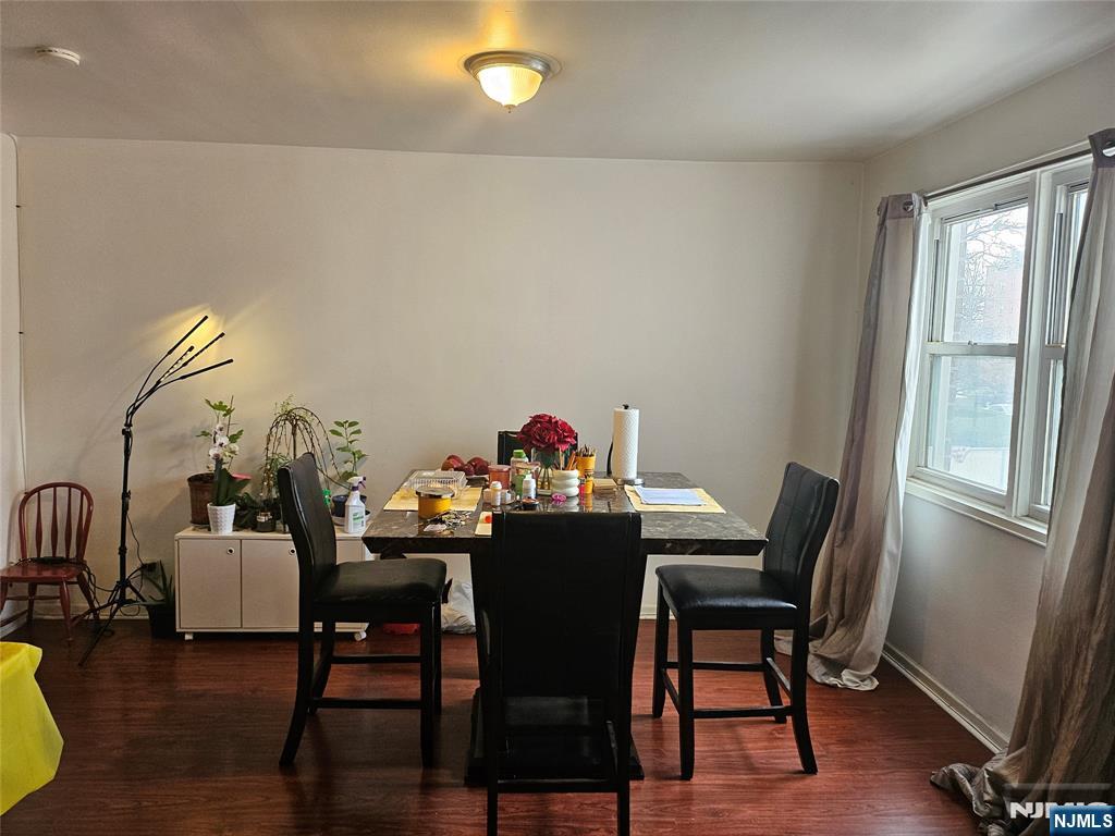 39 East 39th Street, Unit 1E Paterson, NJ 07514 - Photo 6 of 18 a view of a dining room with furniture and wooden floor