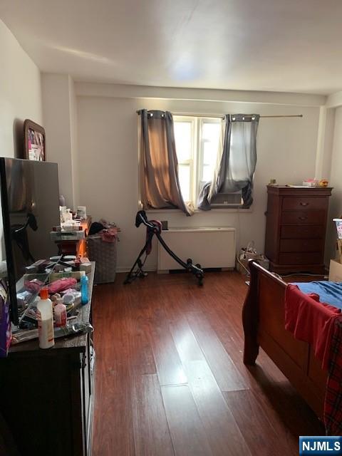 39 East 39th Street, Unit 1E Paterson, NJ 07514 - Photo 9 of 18 a bedroom with furniture and a wooden floor