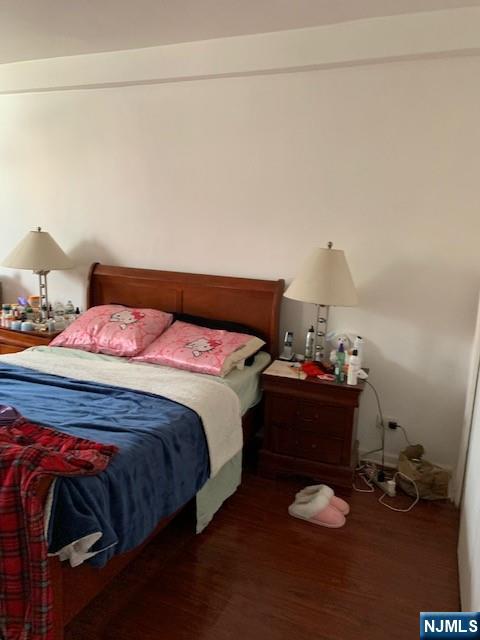 39 East 39th Street, Unit 1E Paterson, NJ 07514 - Photo 10 of 18 a bedroom with a bed and cabinets