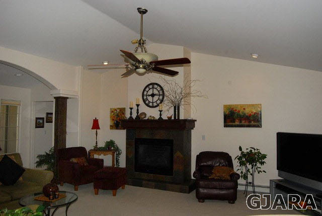 1677 P Road Loma, CO 81524 - Photo 2 of 14 a living room with furniture a flat screen tv and a fireplace