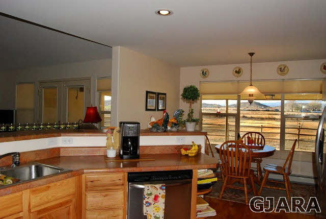 1677 P Road Loma, CO 81524 - Photo 7 of 14 a view of a dining room with furniture and chandelier
