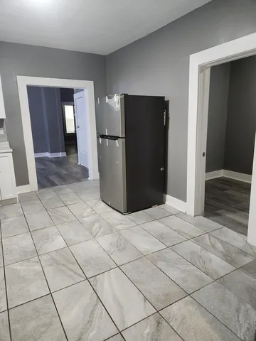 an empty room with wooden floor and white walls