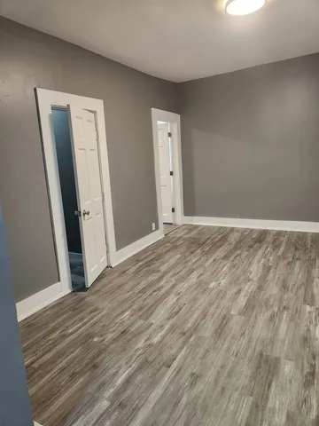 a view of room with wooden floor