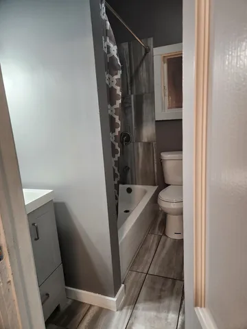 a white toilet sitting next to a bath tub shower