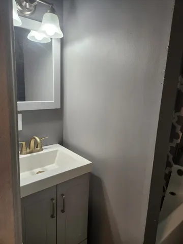 a view of a room that has wooden floor and a window