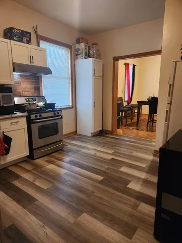 a kitchen with granite countertop a stove and a refrigerator