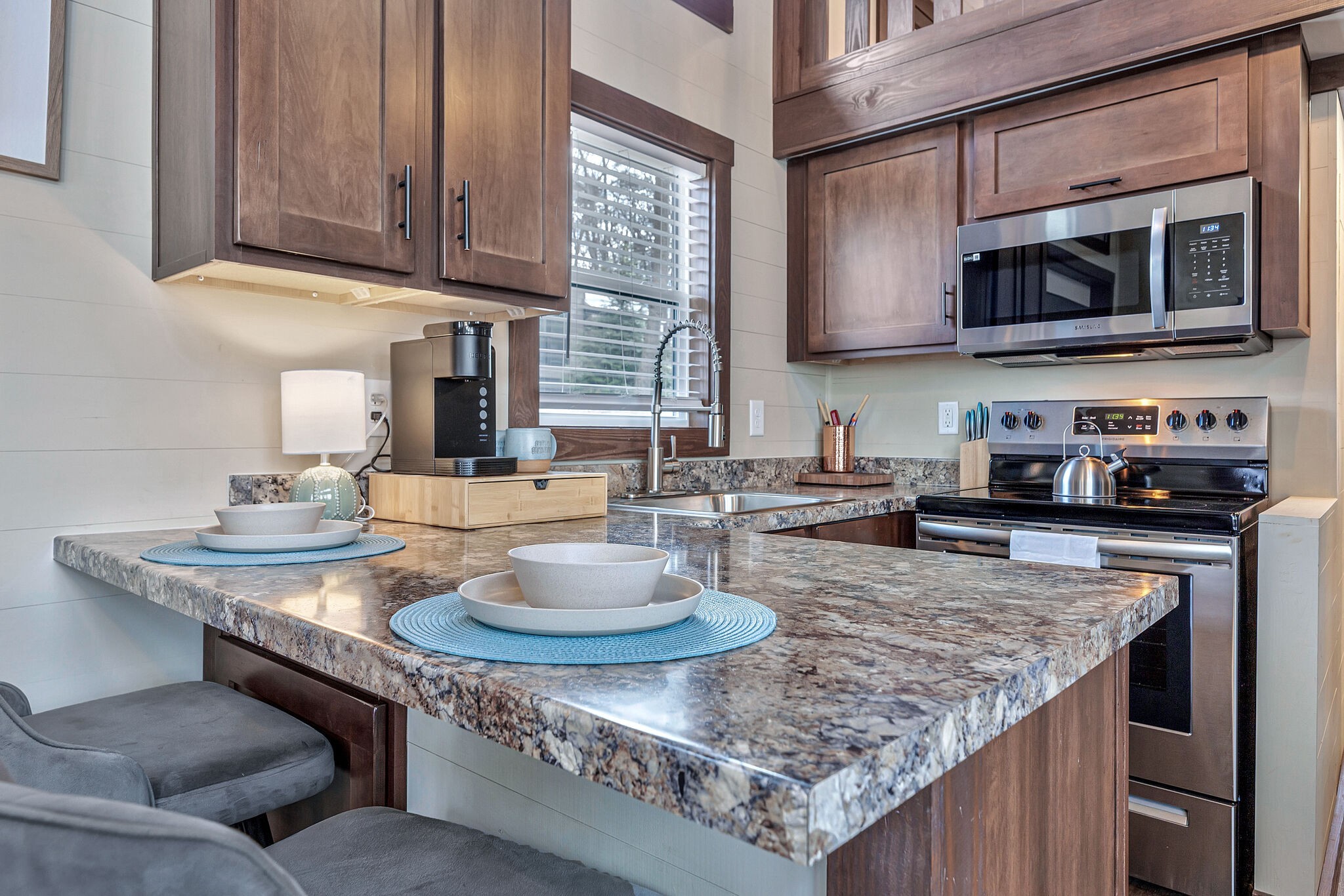 42 Oakleaf Trail Tracy City, TN 37387 - Photo 16 of 73 a kitchen with granite countertop a sink a stove and a microwave