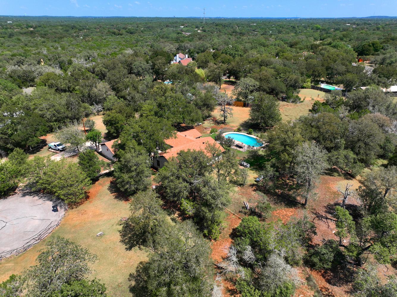 2300 Robin Road Manchaca, TX 78652 - Photo 32 of 36 Mature trees surround this private estate featuring an inviting in-ground swimming pool.