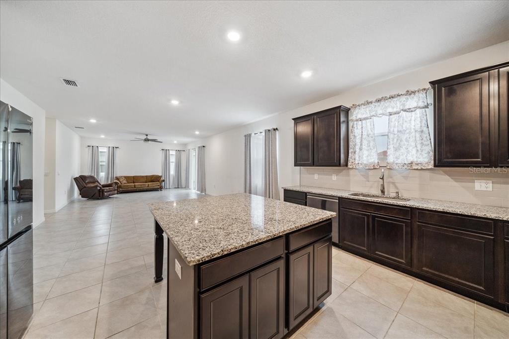 8110 Southwest 59th Terrace Ocala, FL 34476 - Photo 11 of 35 a kitchen with a sink and a refrigerator