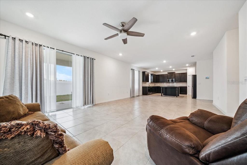 8110 Southwest 59th Terrace Ocala, FL 34476 - Photo 13 of 35 a living room with furniture and a ceiling fan