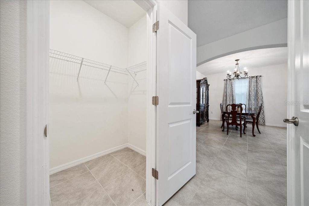 8110 Southwest 59th Terrace Ocala, FL 34476 - Photo 14 of 35 a view of a dining room with furniture and a chandelier fan