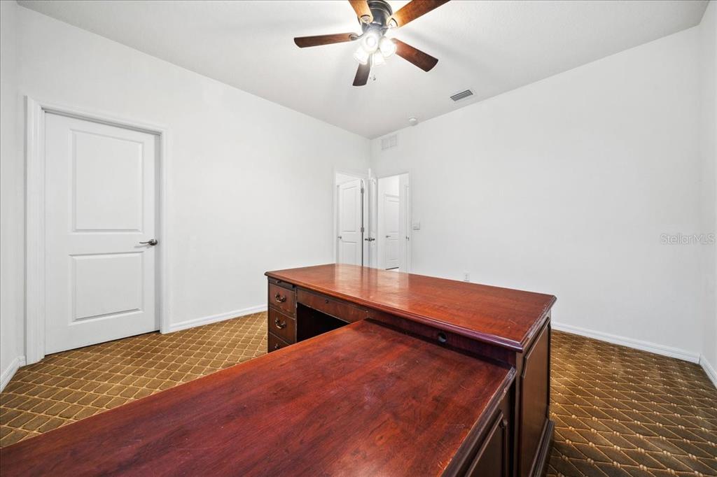 8110 Southwest 59th Terrace Ocala, FL 34476 - Photo 15 of 35 a room with wooden floor and ceiling fan