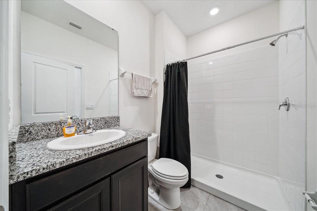 8110 Southwest 59th Terrace Ocala, FL 34476 - Photo 17 of 35 a bathroom with a granite countertop sink toilet and shower