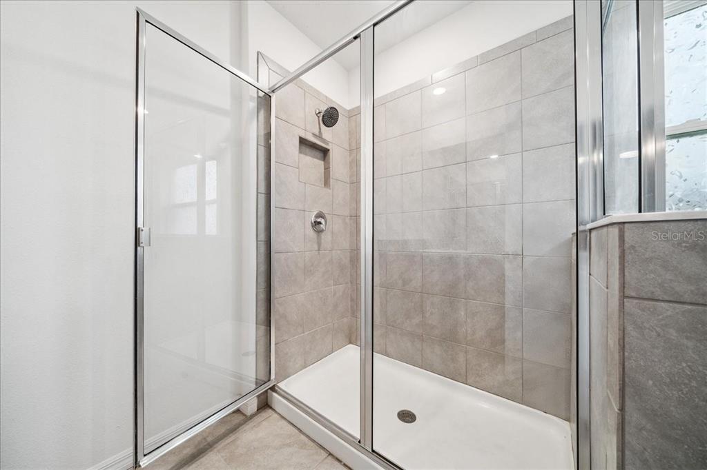 8110 Southwest 59th Terrace Ocala, FL 34476 - Photo 24 of 35 a bathroom with a glass shower door