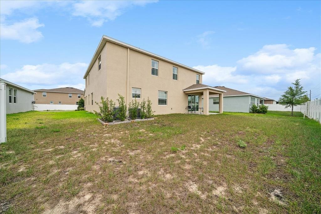 8110 Southwest 59th Terrace Ocala, FL 34476 - Photo 33 of 35 a view of a house with backyard and garden