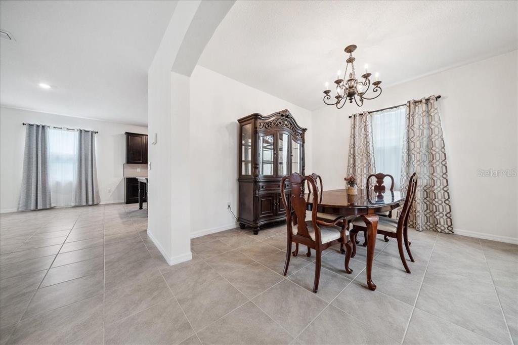 8110 Southwest 59th Terrace Ocala, FL 34476 - Photo 8 of 35 a view of a dining room with furniture and chandelier
