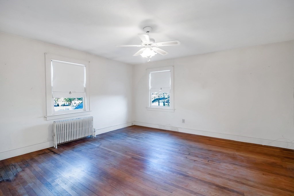 582 Springfield Street Feeding Hills, MA 01030 - Photo 13 of 42 an empty room with wooden floor and ceiling fan
