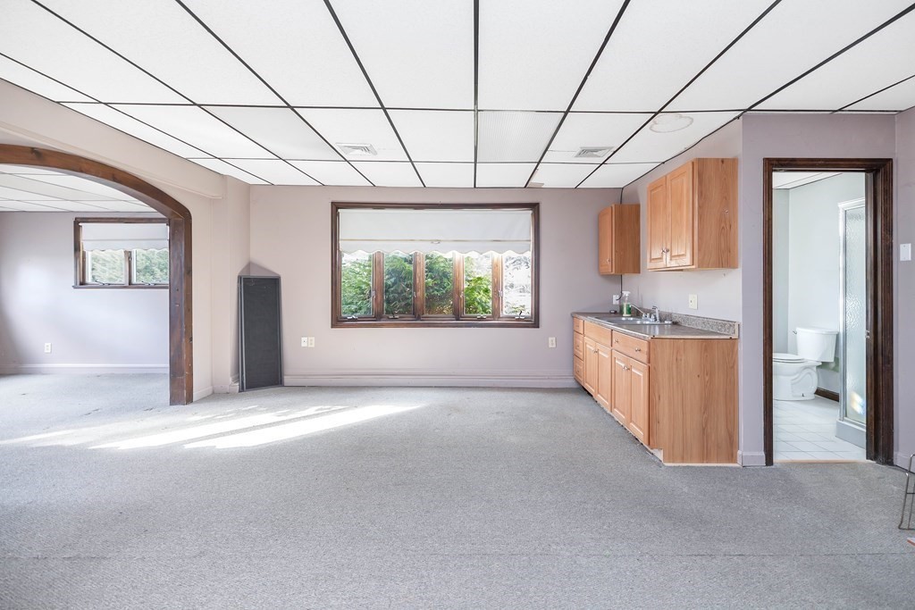 582 Springfield Street Feeding Hills, MA 01030 - Photo 18 of 42 a view of a big room with windows and chandelier