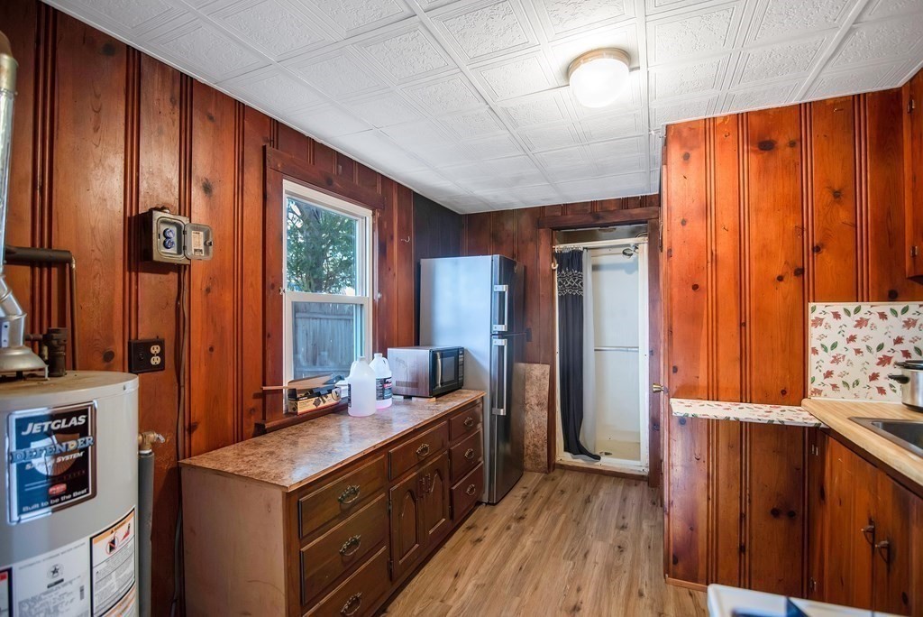 582 Springfield Street Feeding Hills, MA 01030 - Photo 26 of 42 a kitchen with stainless steel appliances granite countertop a refrigerator a sink dishwasher a stove and a dining table with wooden floor