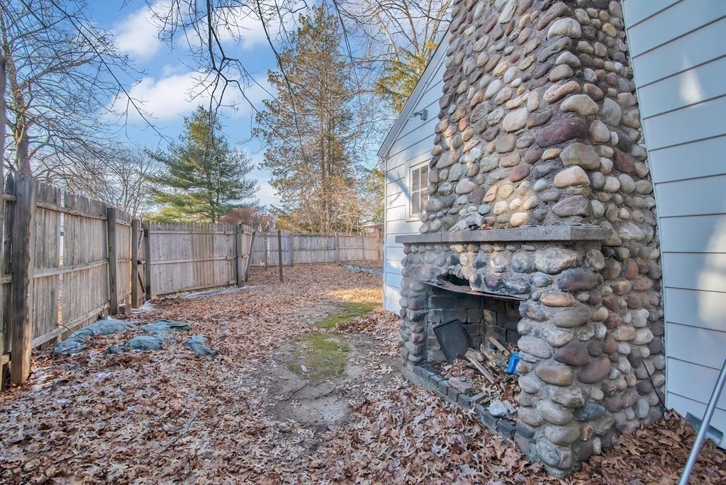 582 Springfield Street Feeding Hills, MA 01030 - Photo 28 of 42 a backyard of a house with large trees and wooden fence