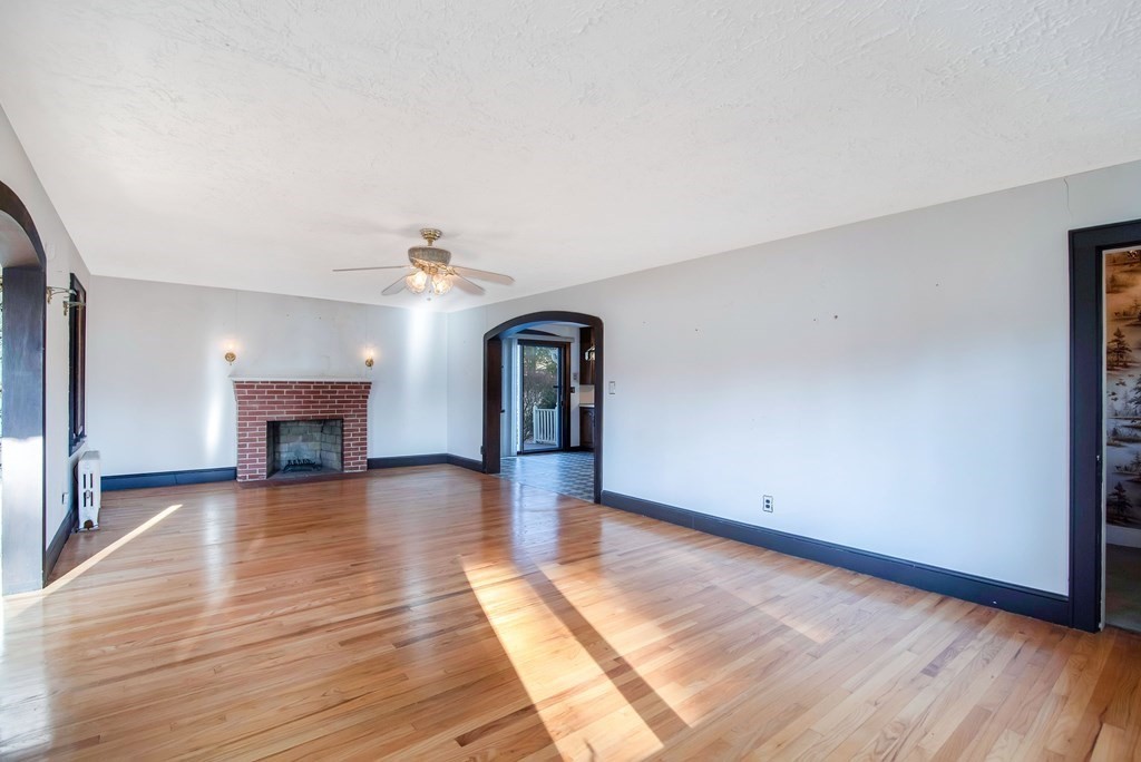 582 Springfield Street Feeding Hills, MA 01030 - Photo 3 of 42 a view of a livingroom with wooden floor and a fireplace