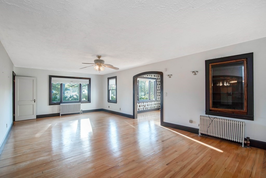 582 Springfield Street Feeding Hills, MA 01030 - Photo 5 of 42 an empty room with wooden floor and windows