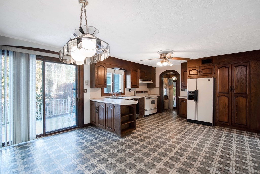 582 Springfield Street Feeding Hills, MA 01030 - Photo 6 of 42 a view of a kitchen with refrigerator and wooden floor