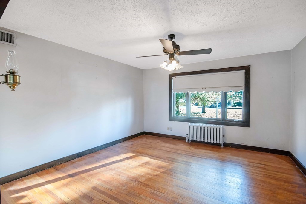 582 Springfield Street Feeding Hills, MA 01030 - Photo 9 of 42 a view of empty room with wooden floor and fan