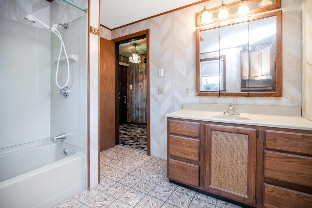 582 Springfield Street Feeding Hills, MA 01030 - Photo 10 of 42 a bathroom with a tub a sink and a mirror