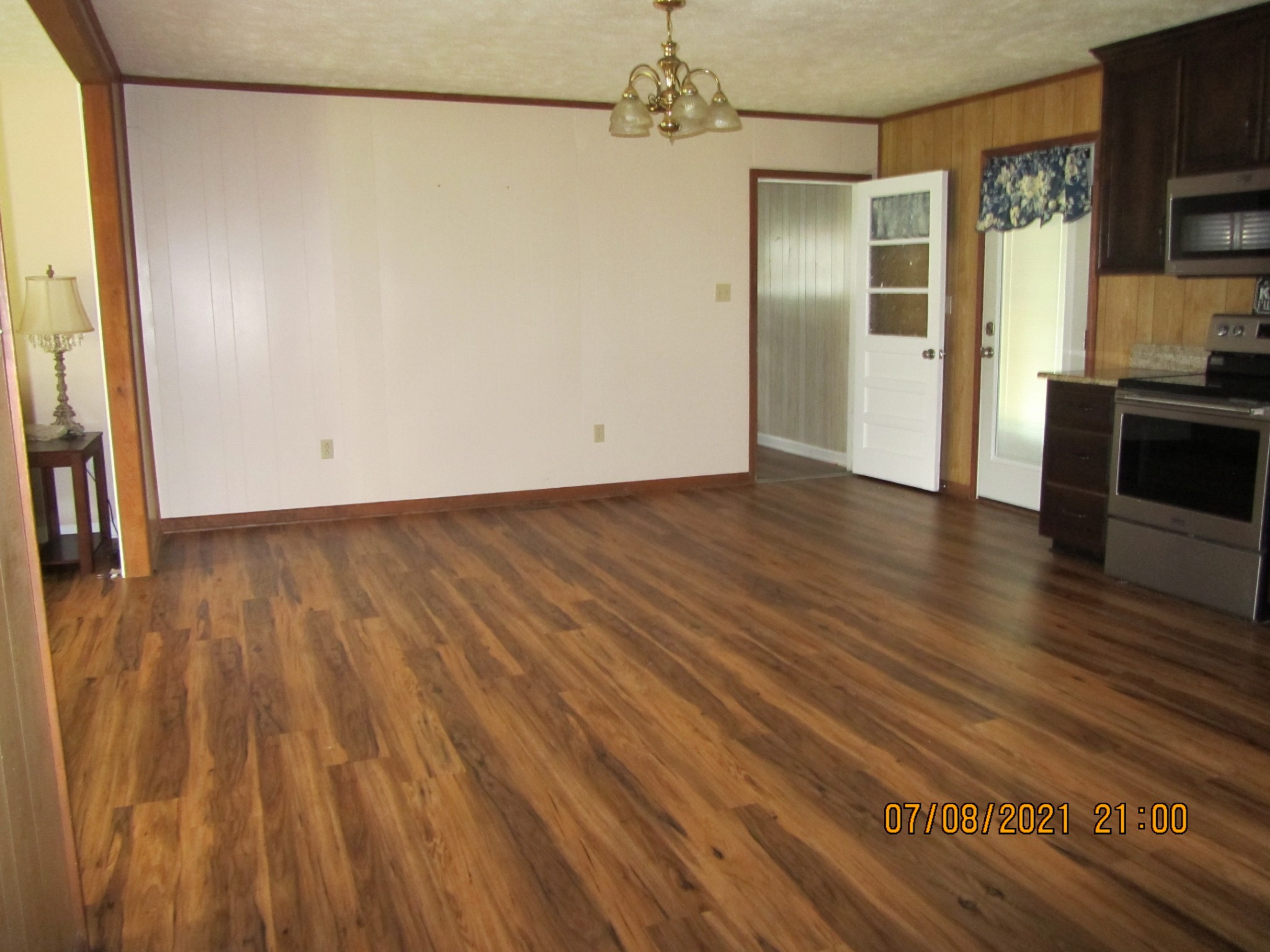 751 Palmyra Road Clarksville, TN 37040 - Photo 8 of 22 an empty room with wooden floor and a fireplace