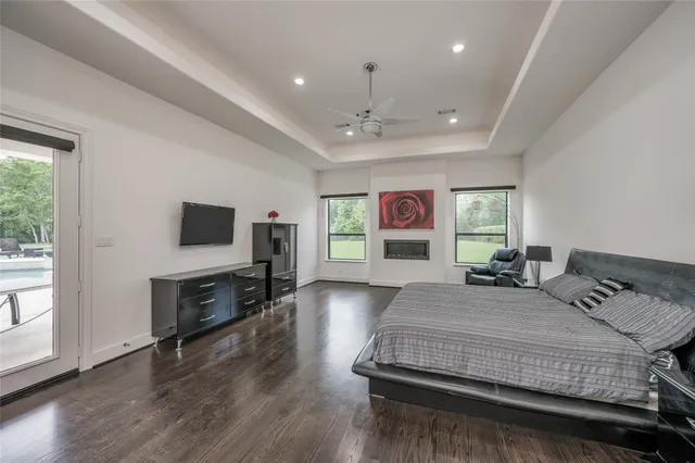 a bedroom with a bed window and a flat screen tv