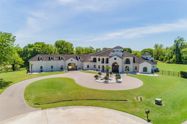 an aerial view of a house with swimming pool garden and patio