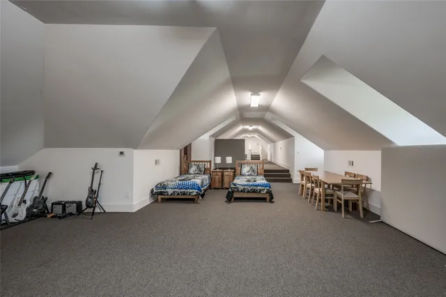 a room with stainless steel appliances and a book shelf