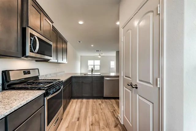 a kitchen with stainless steel appliances granite countertop a stove and a refrigerator