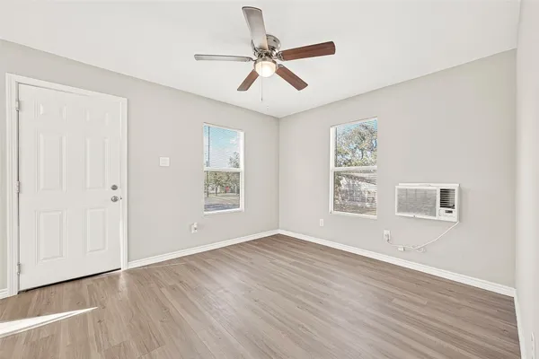 a view of a livingroom with wooden floor and a ceiling fan