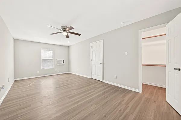 a kitchen with granite countertop cabinets stainless steel appliances a sink and wooden floor