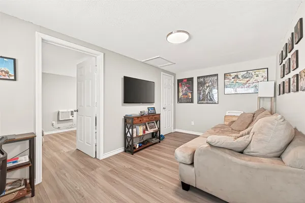 a kitchen with a white cabinets a sink dishwasher and a stove with wooden floor