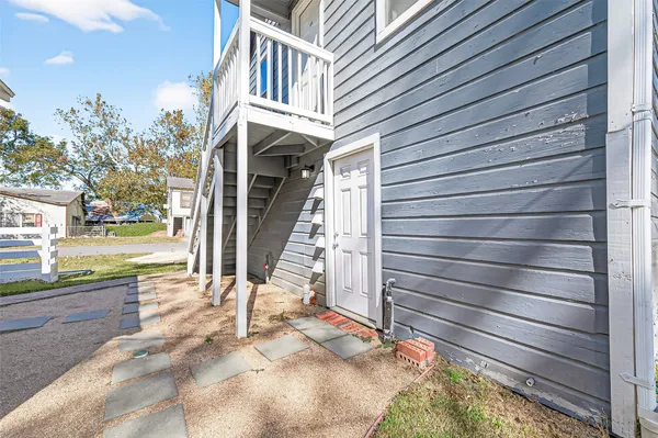 a view of a house with a small deck
