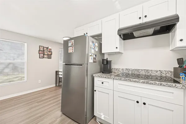 a kitchen with stainless steel appliances granite countertop a refrigerator sink and cabinets